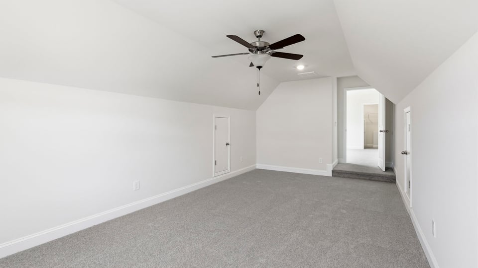 Loft with carpet and windows.