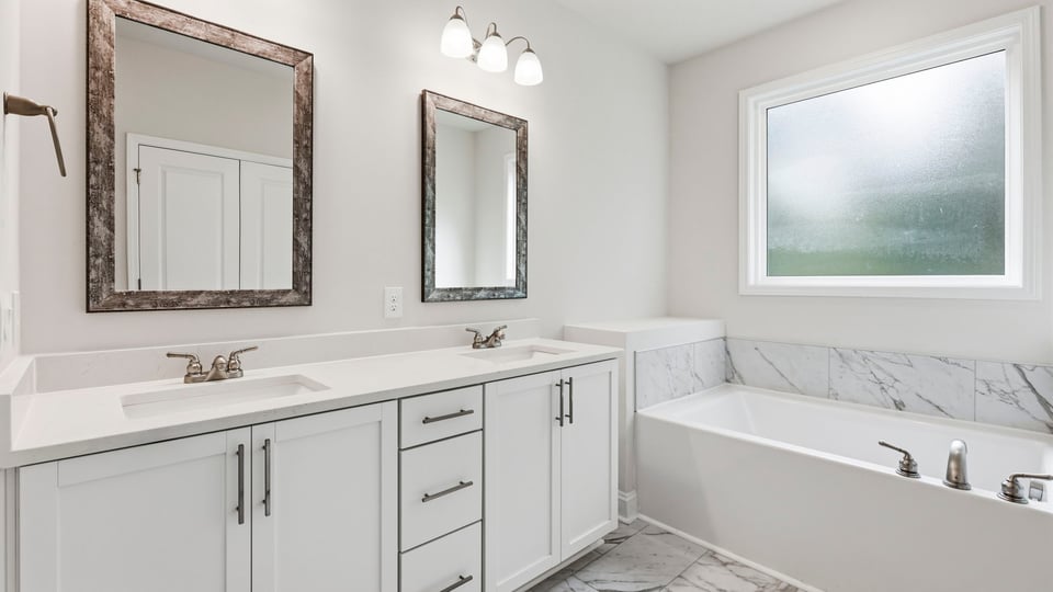 Primary bathroom with double vanity sinks.
