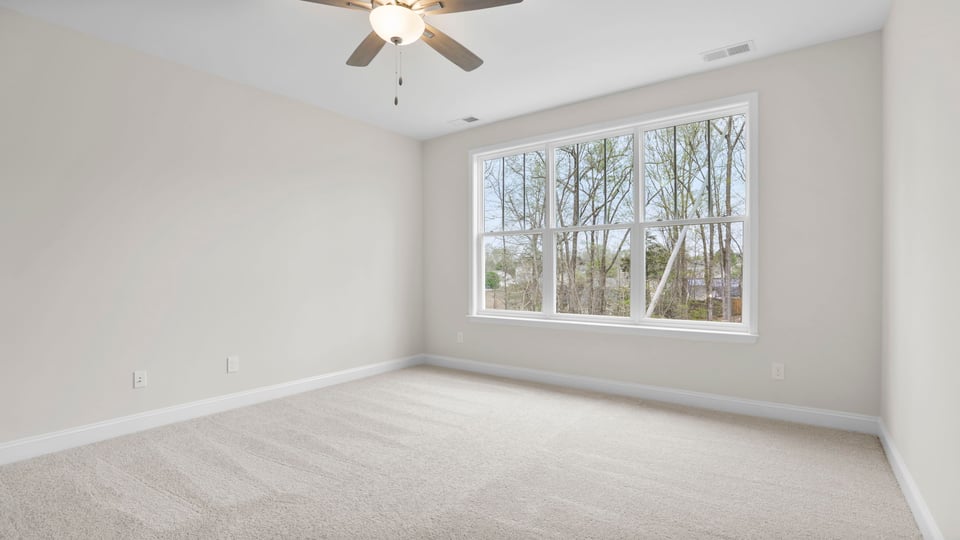 Bedroom with carpet and window.
