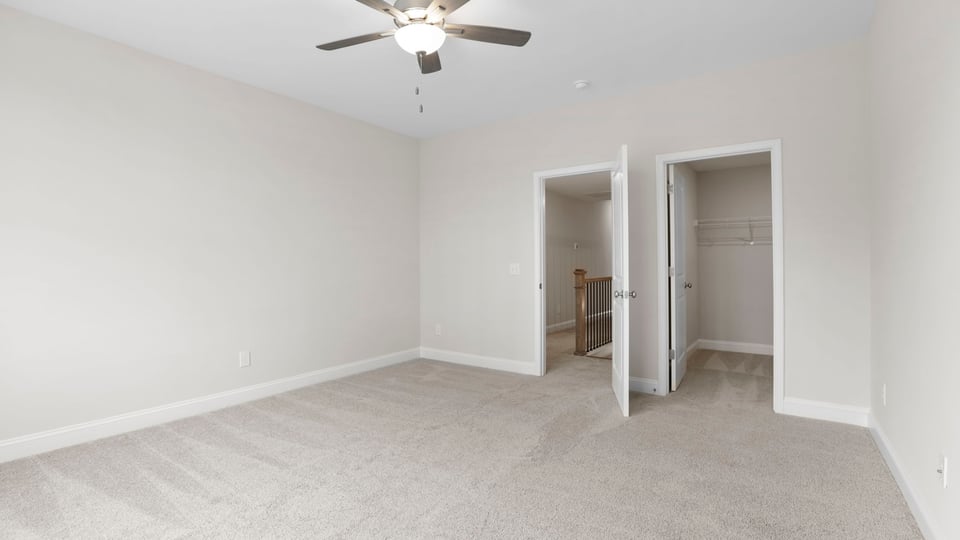 Bedroom with carpet and window.