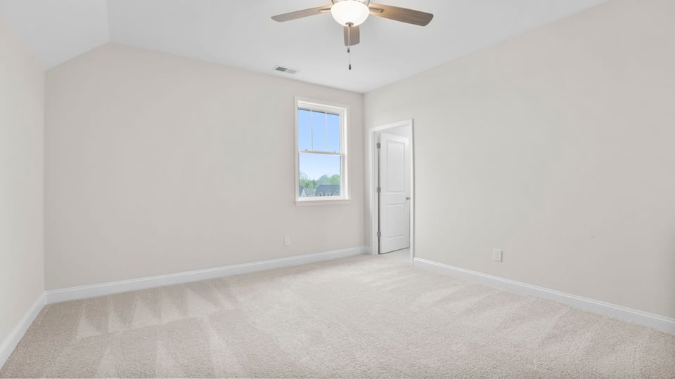 Bedroom with carpet and window.
