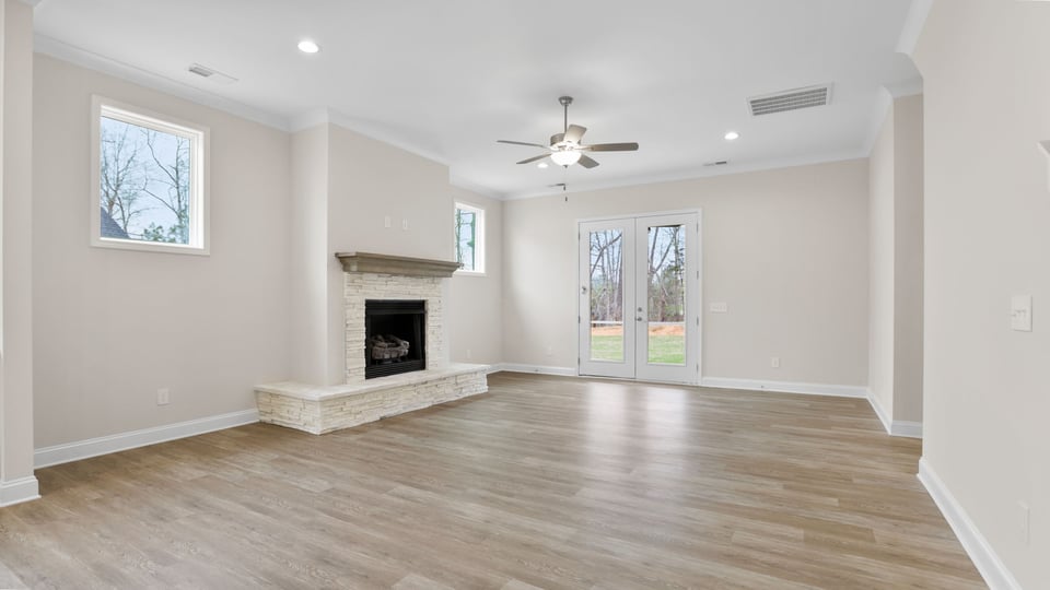 Living area with fireplace and windows.