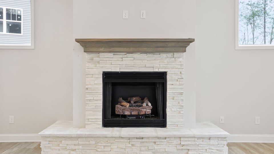 Living area with fireplace and windows.