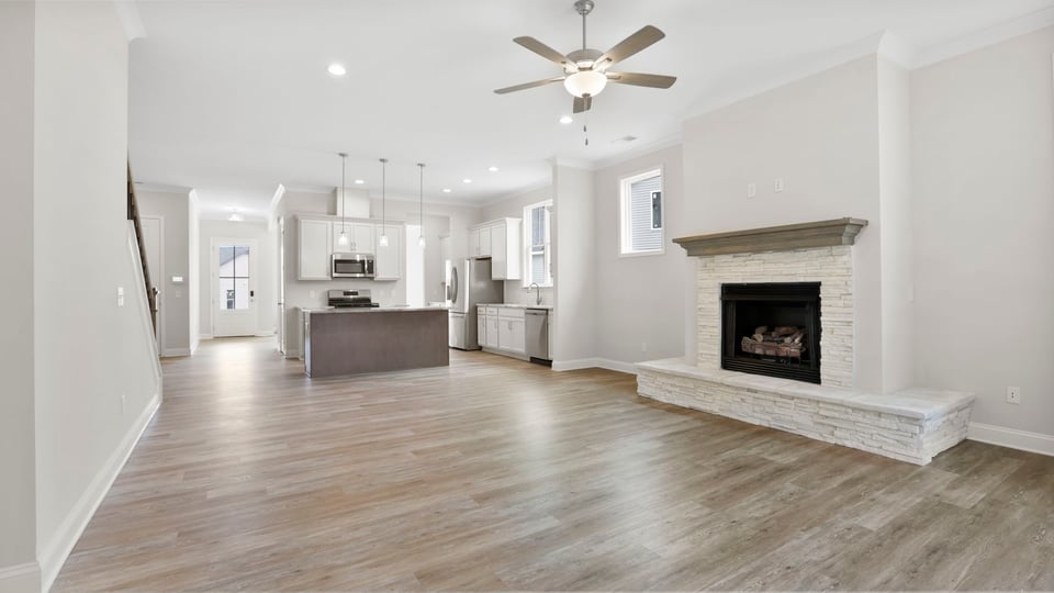Living area with fireplace and windows.