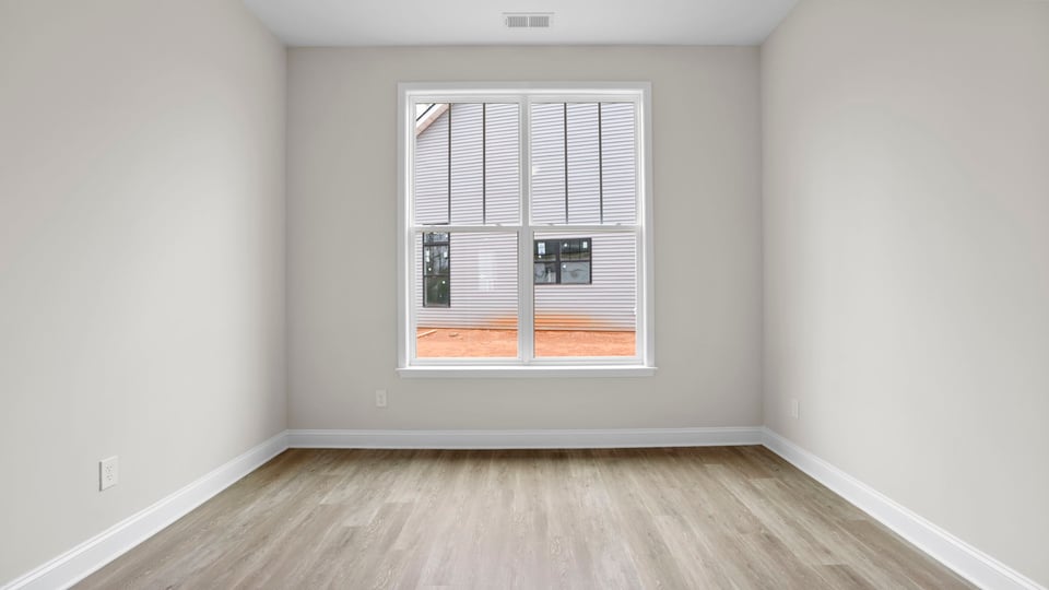 Bedroom with carpet and window.