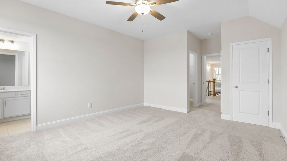 Bedroom with carpet and windows.