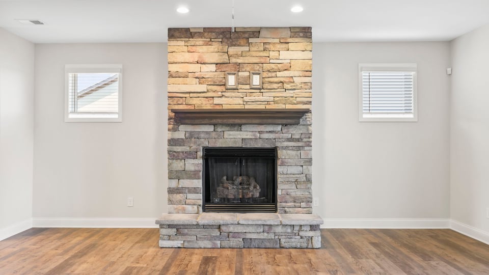 Living area with fireplace and windows.