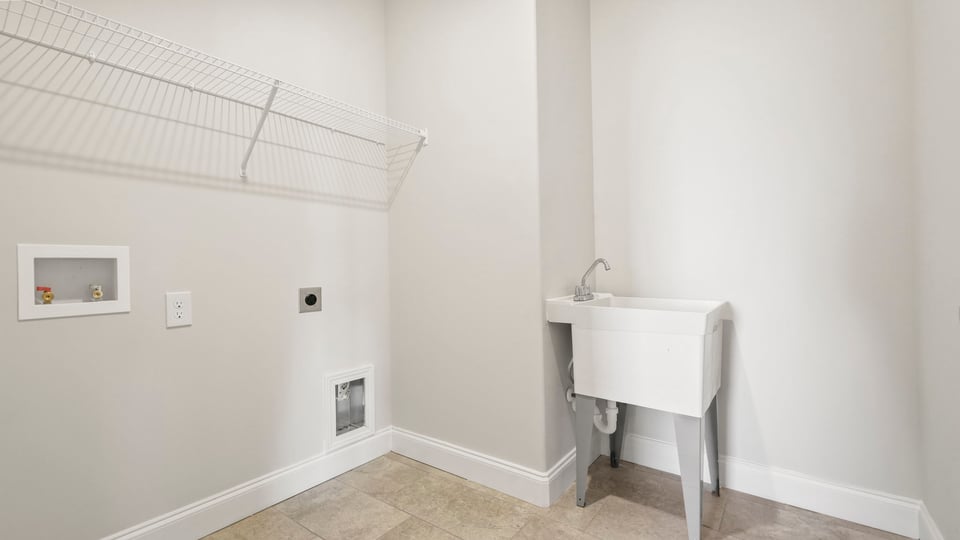Laundry room with shelf.