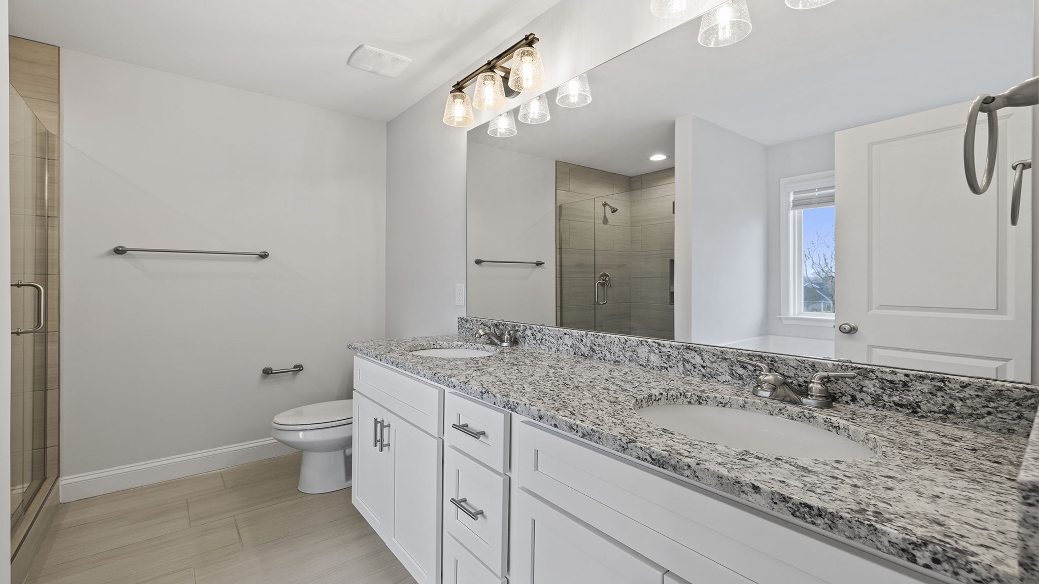 Primary bathroom with double vanity sinks.