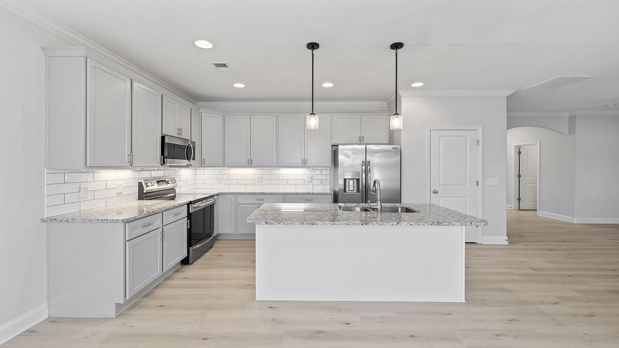 Kitchen with island and cabinets.