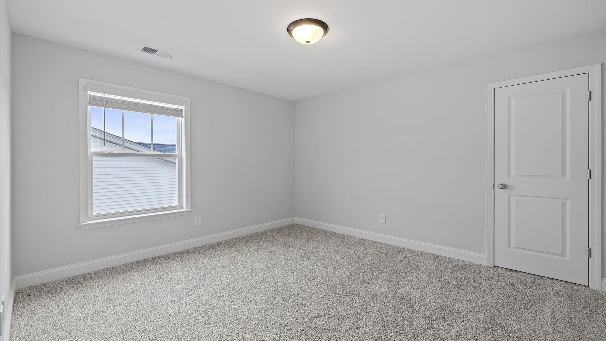 Bedroom with carpet and windows.