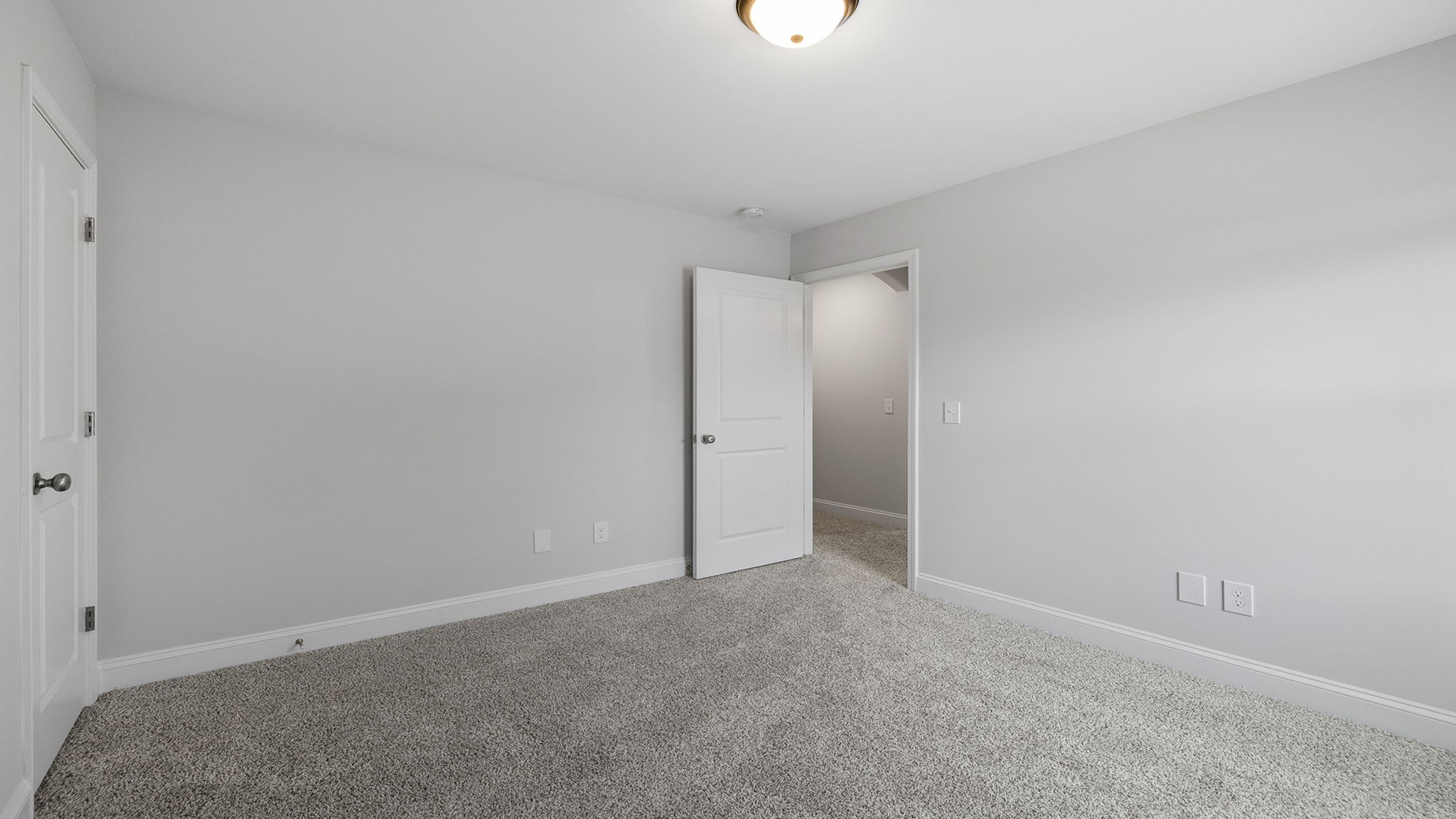 Bedroom with carpet and windows.