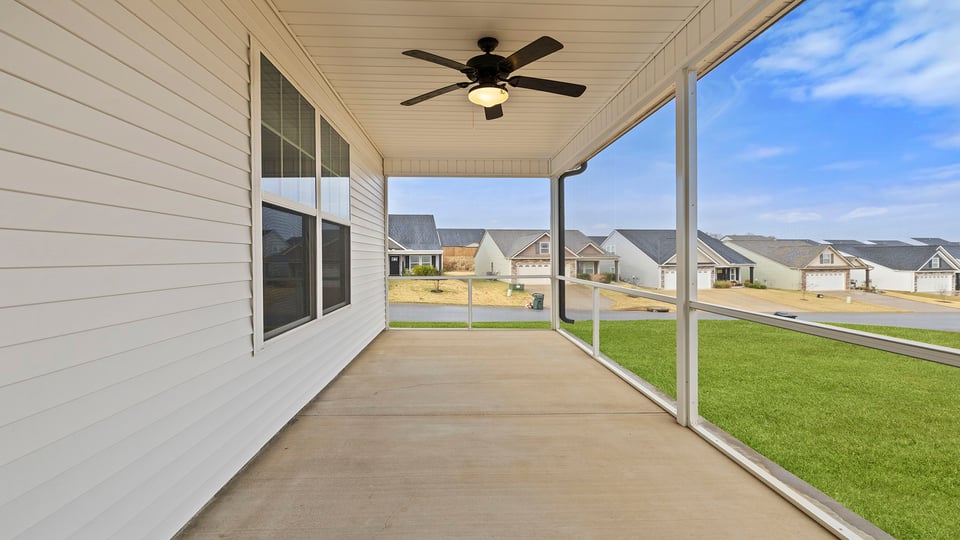 Back exterior with patio and large backyard.