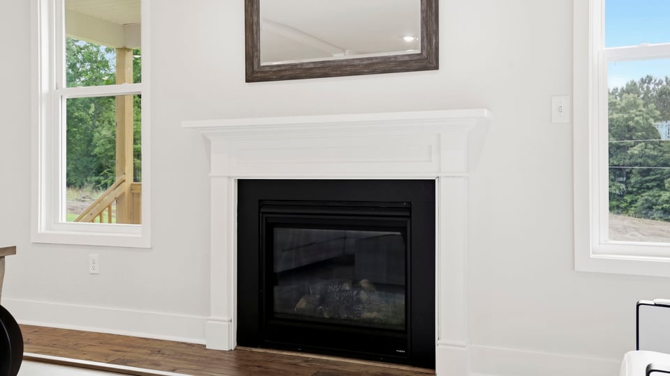Living area with windows and fireplace.