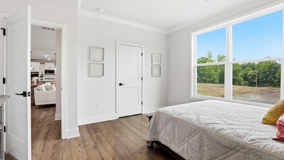 Bedroom with carpet and window.
