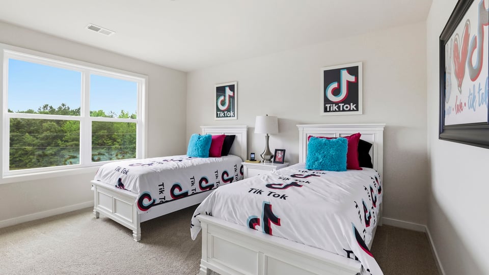 Bedroom with carpet and window.