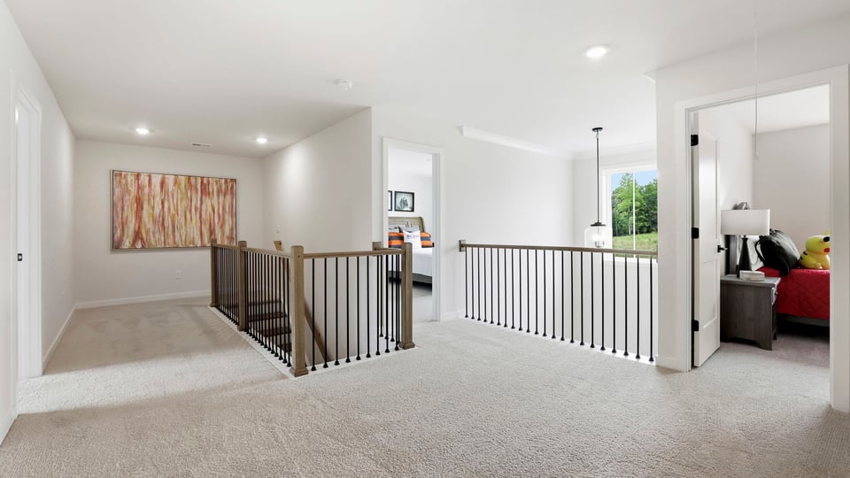 Loft area with carpet and window.