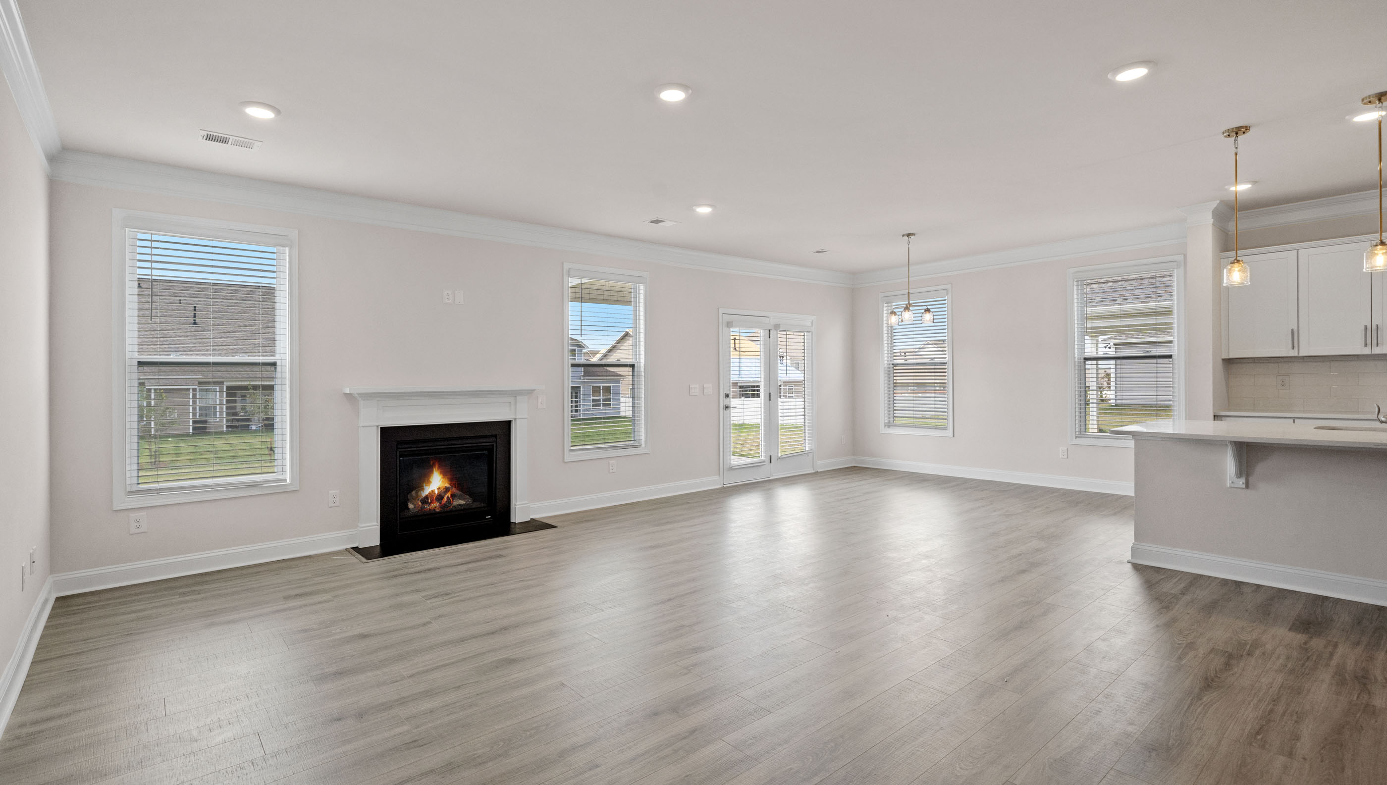 Family room is open to the kitchen with lots of windows and gas log fireplace.
