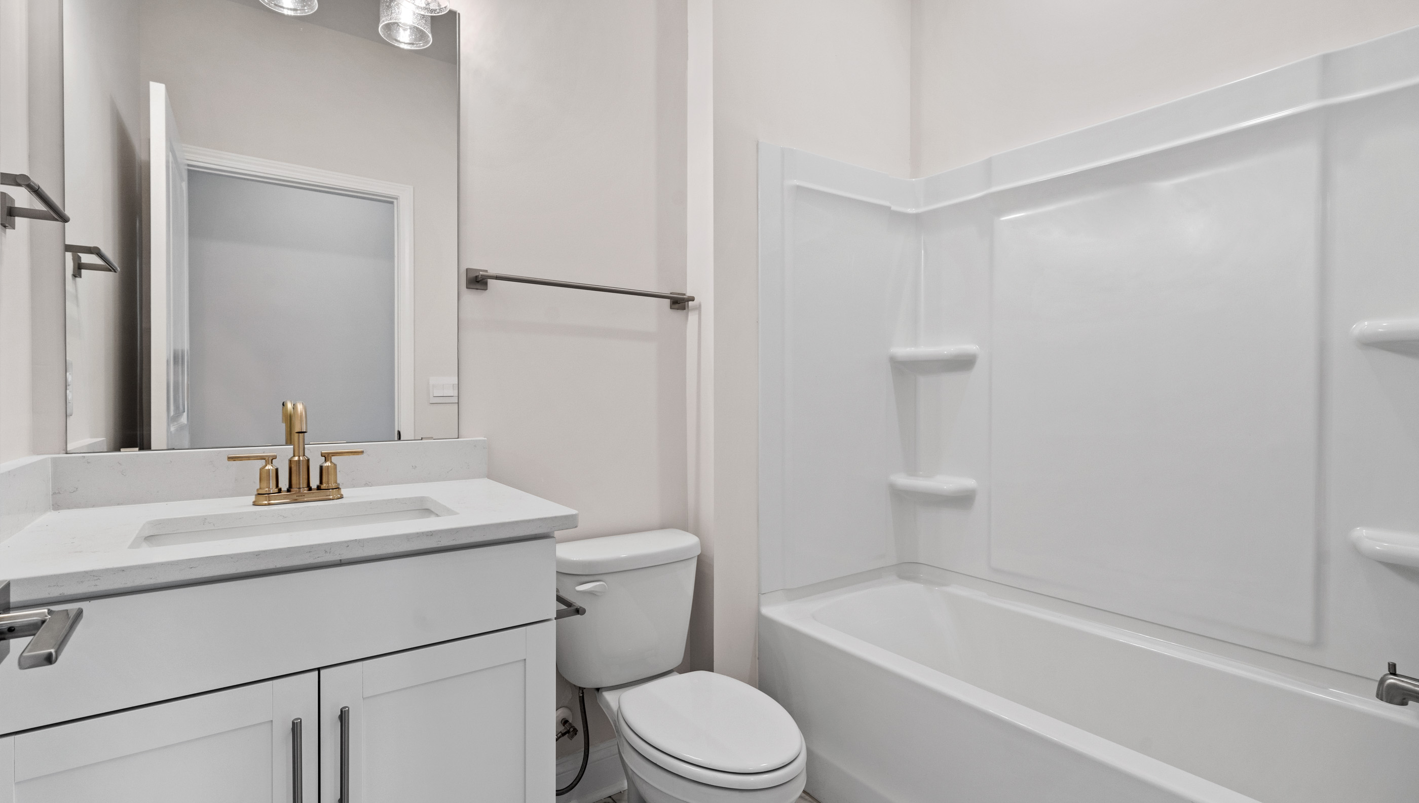 Full bathroom on the main level with vanity and combination shower / tub.