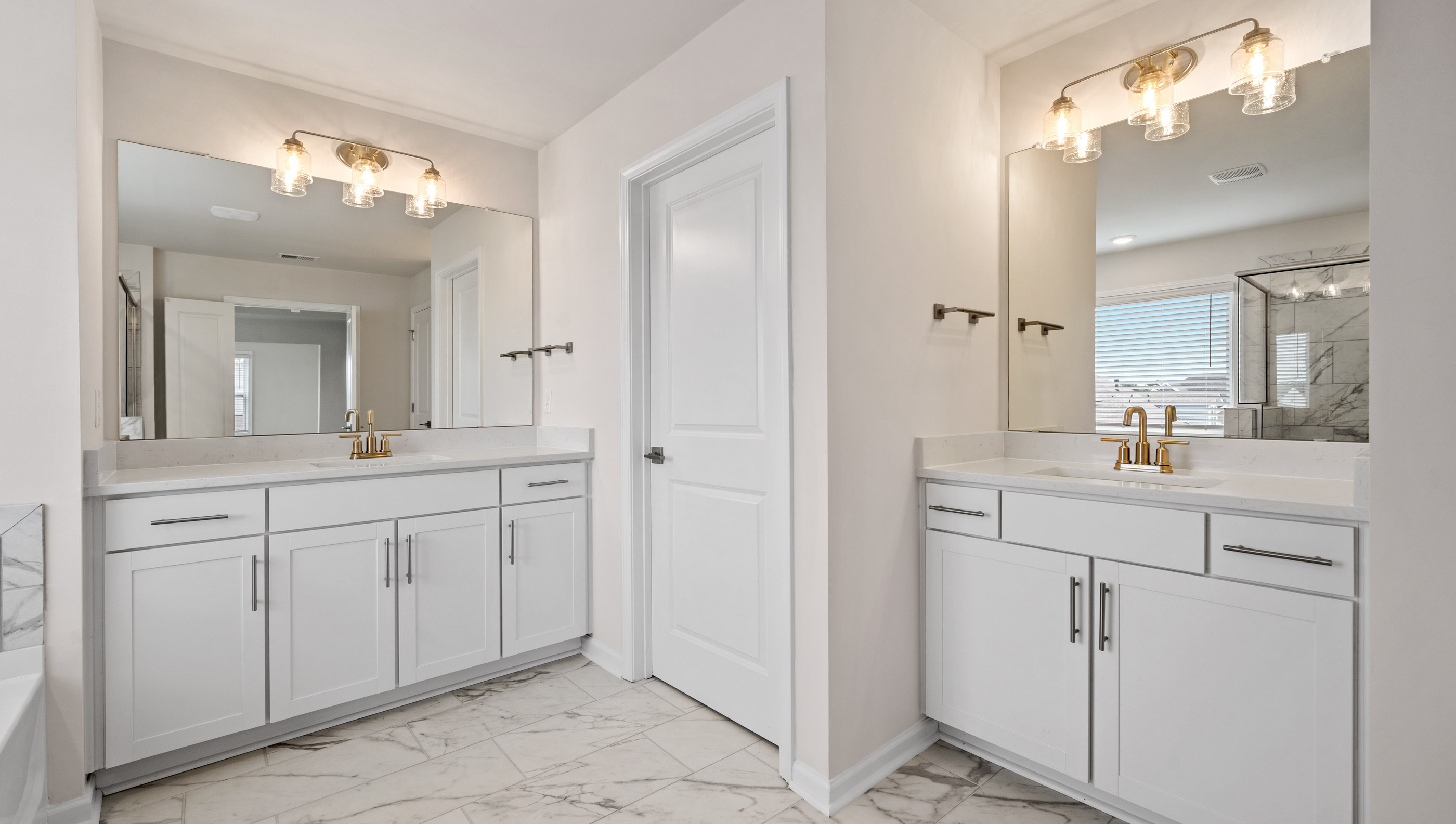 Primary bathroom with his and her vanities.