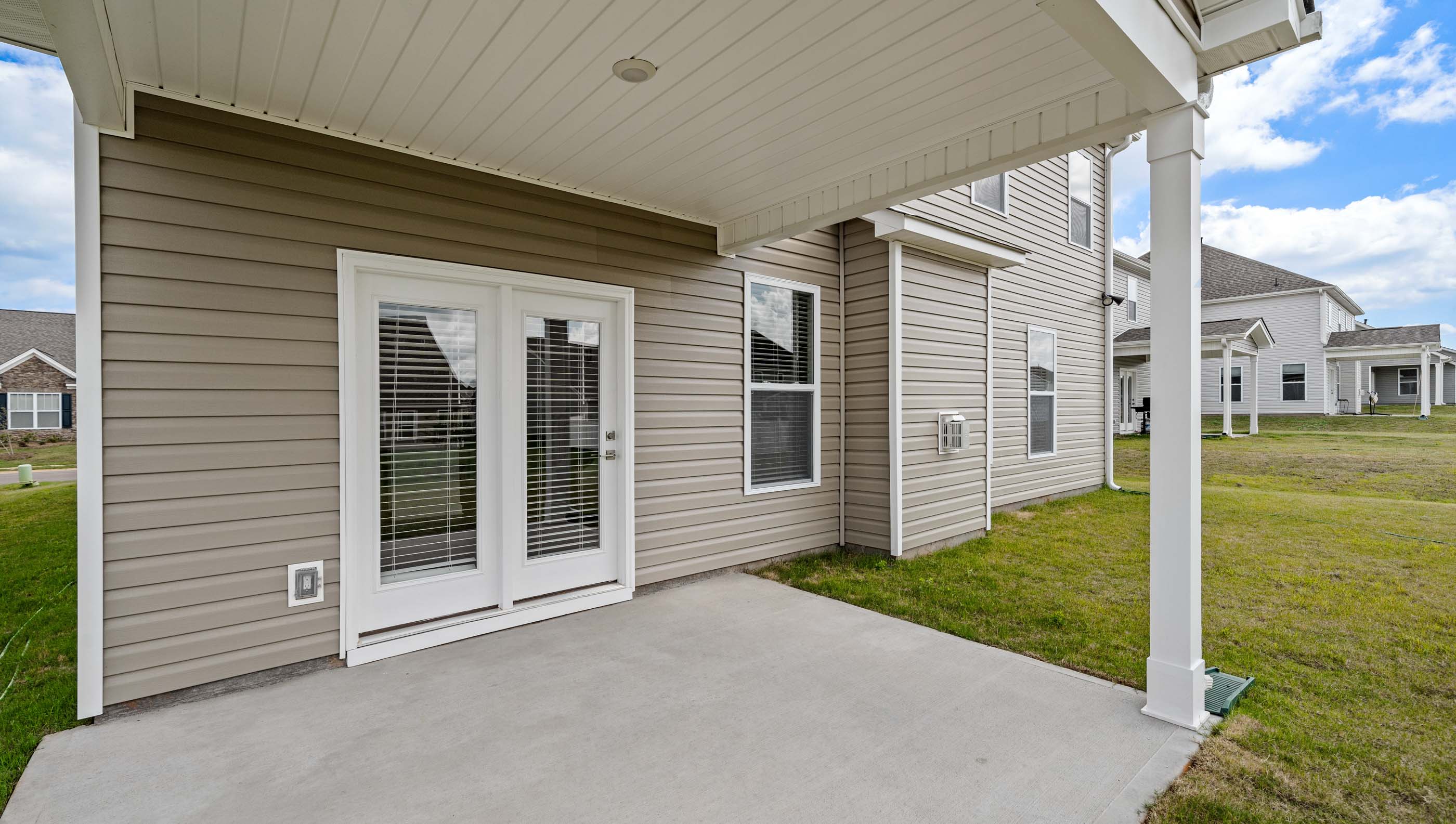 Covered porch over looks the back yard.