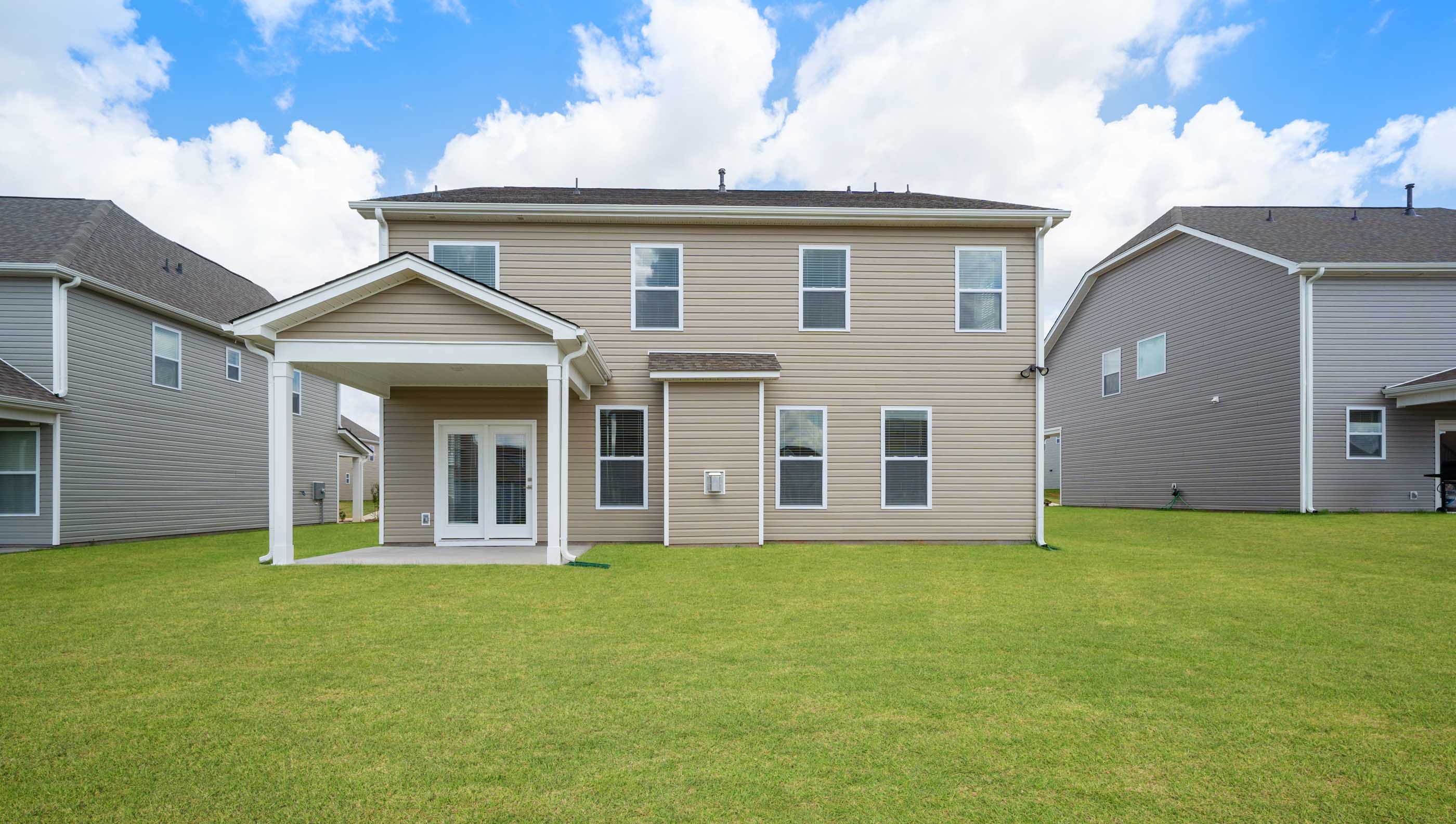 Back exterior view of the Hampshire home and large back yard