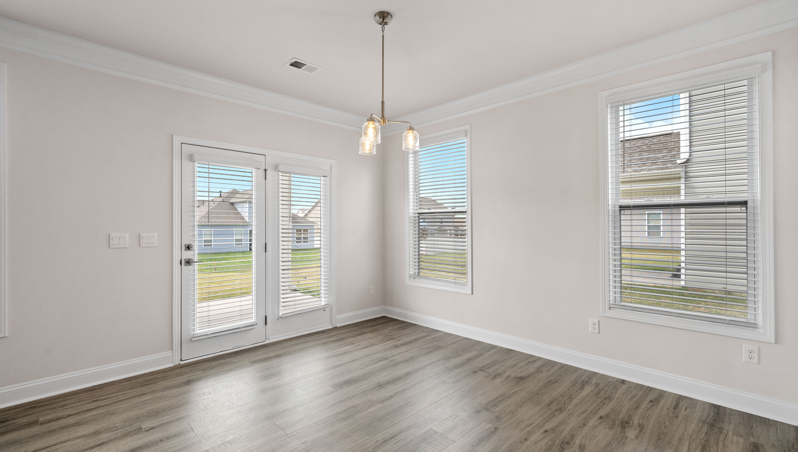 Breakfast area with lots of windows and door to the back yard and covered porch.