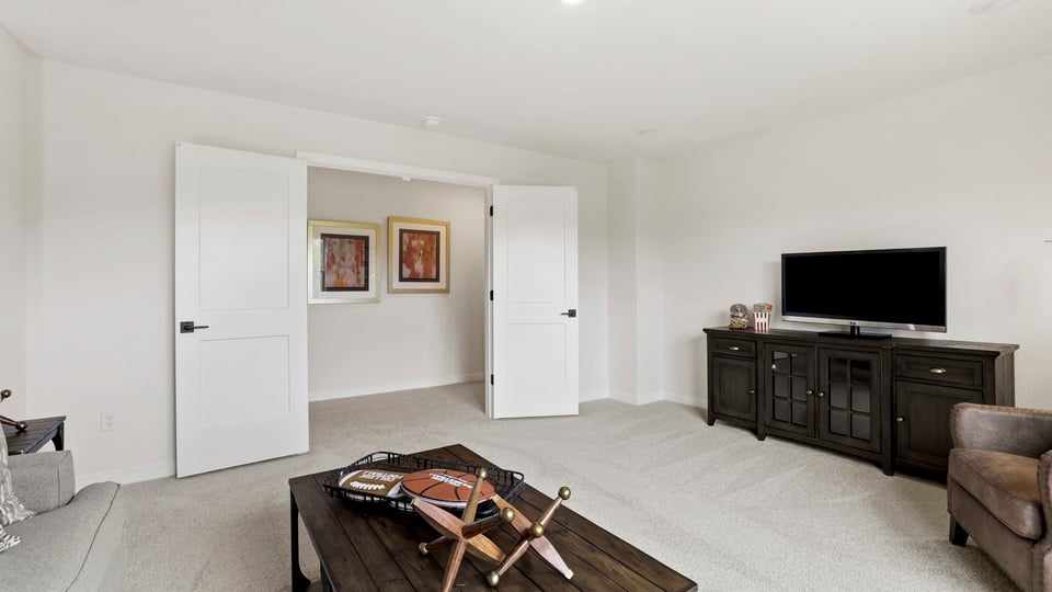 Loft area with carpet and window.