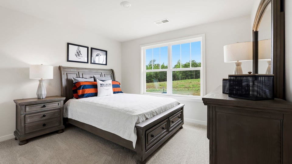 Bedroom with carpet and window.