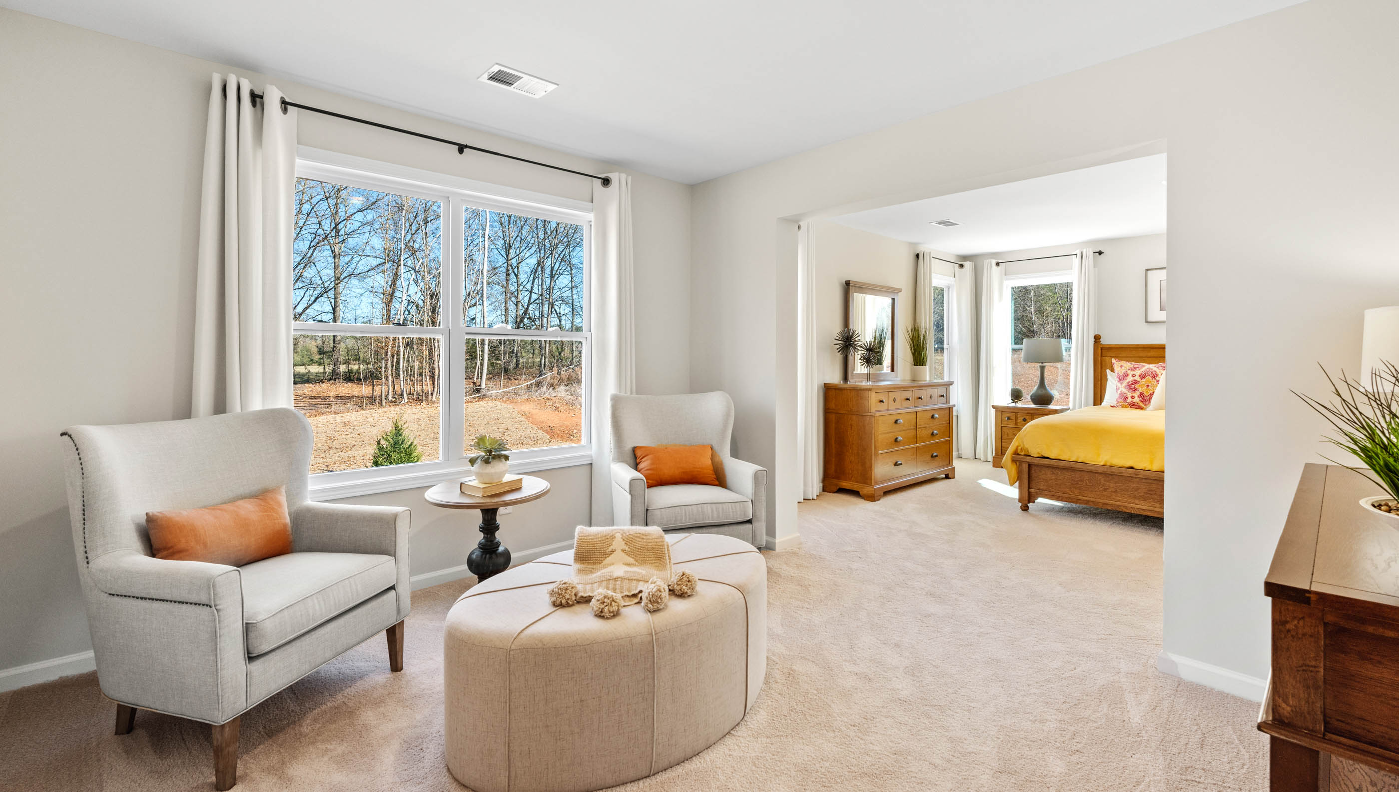 Primary bedroom with window and carpet.