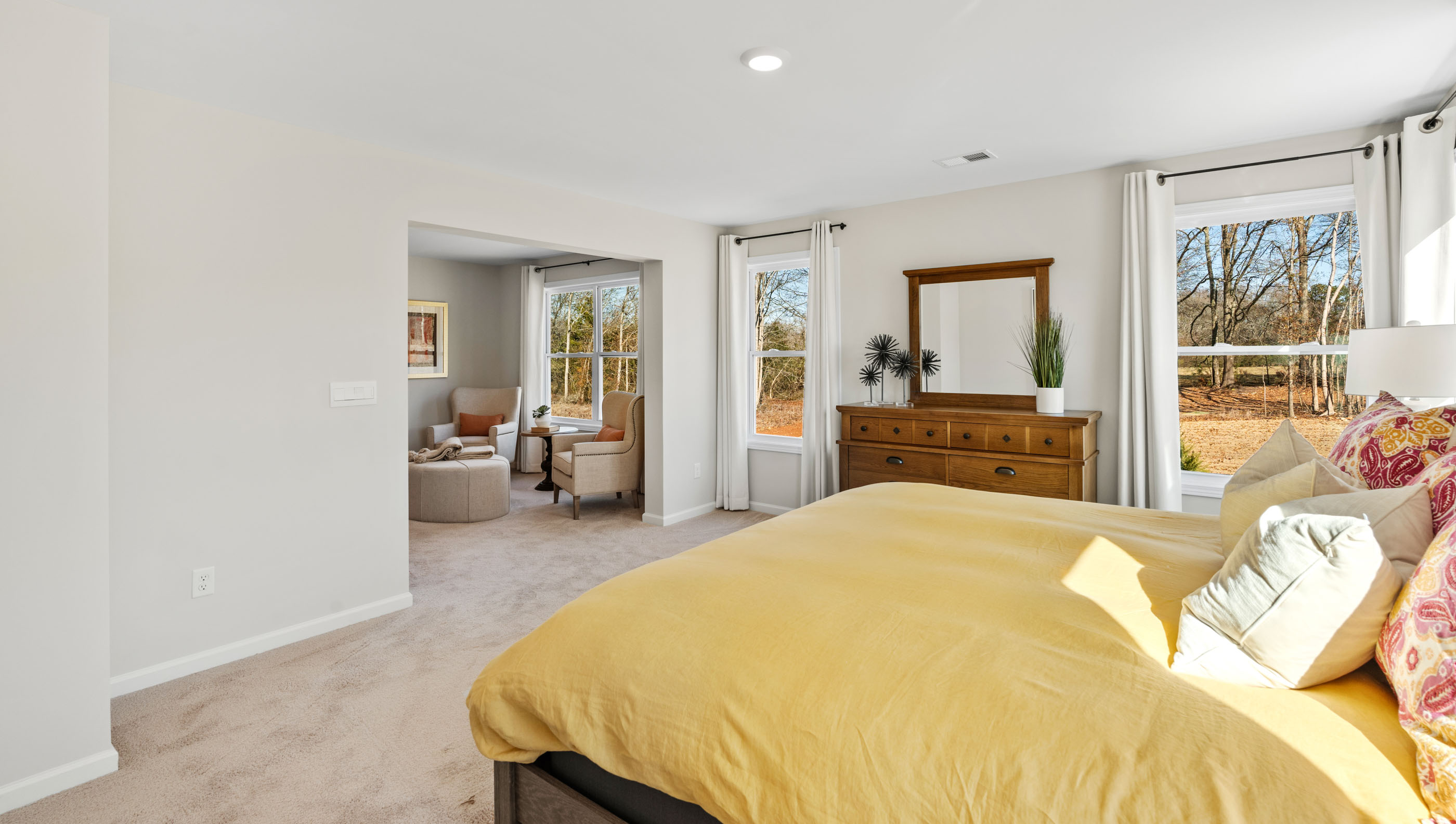 Primary bedroom with window and carpet.