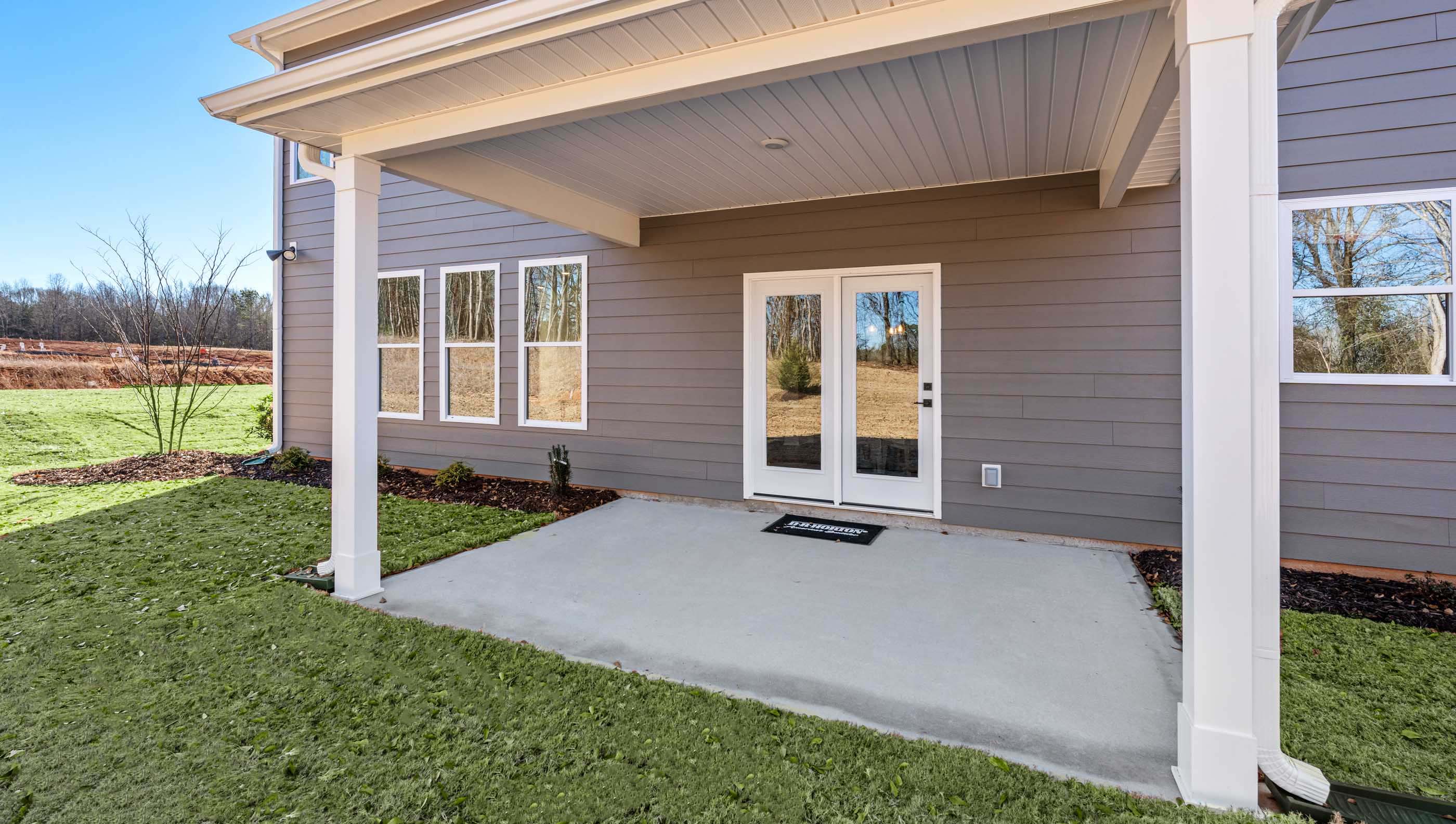Covered patio with large backyard.