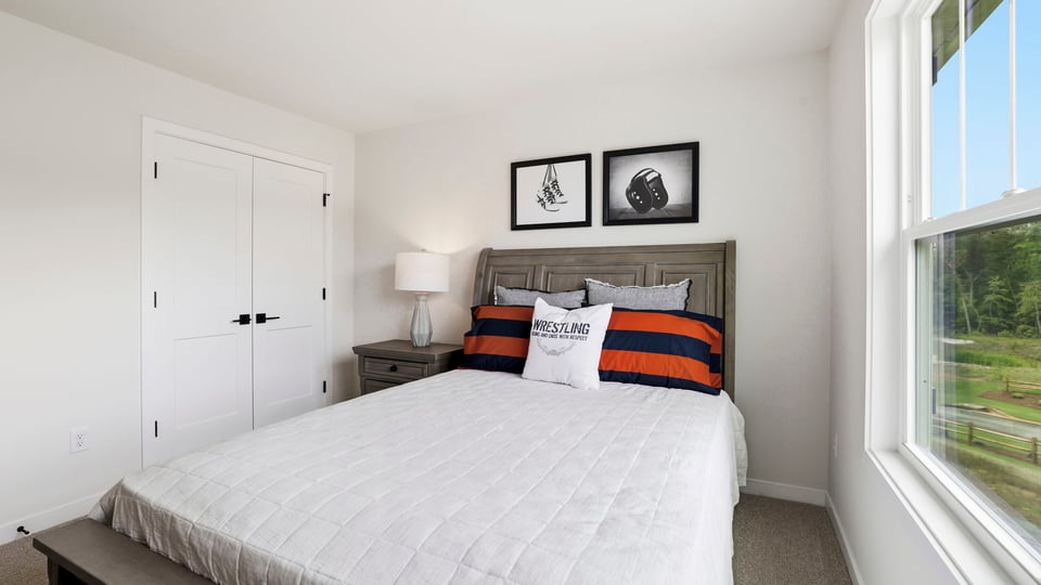 Bedroom with carpet and window.