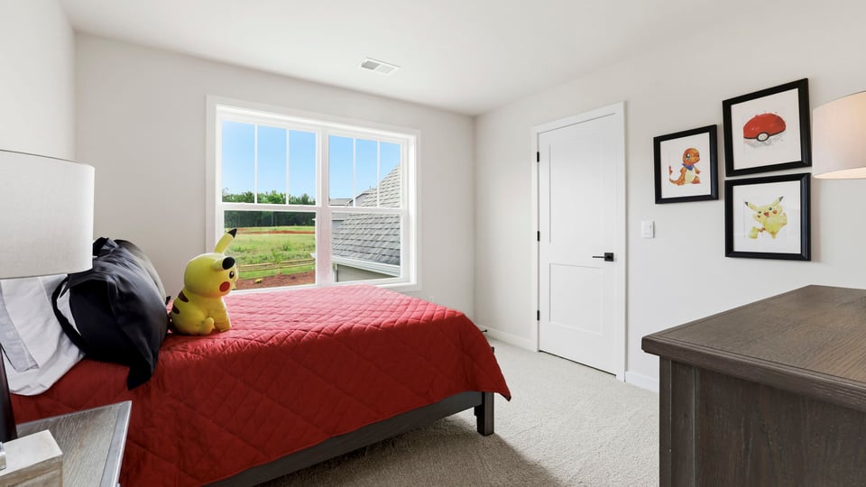 Bedroom with carpet and window.