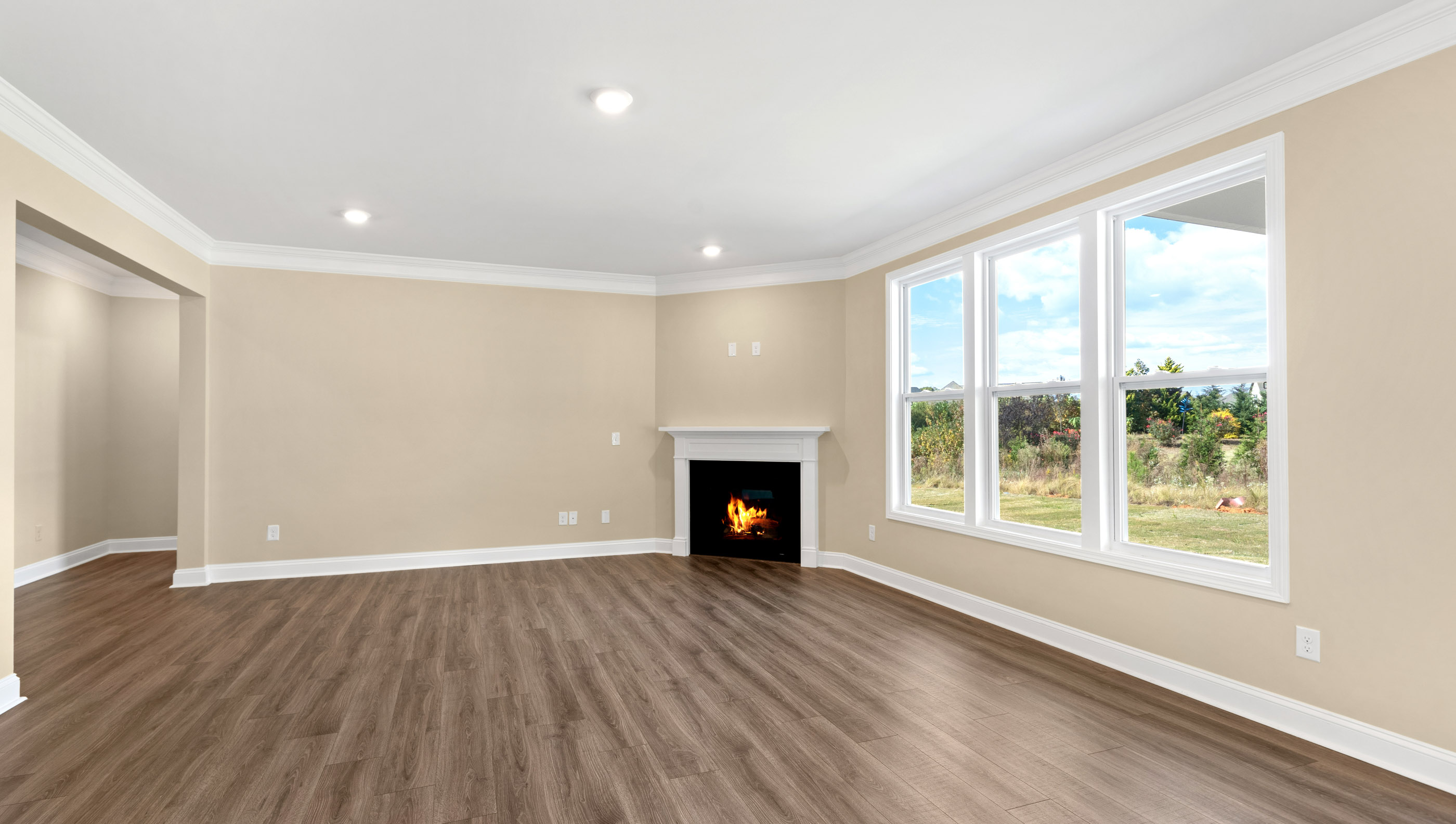Family room with three large windows to let in the natural light.