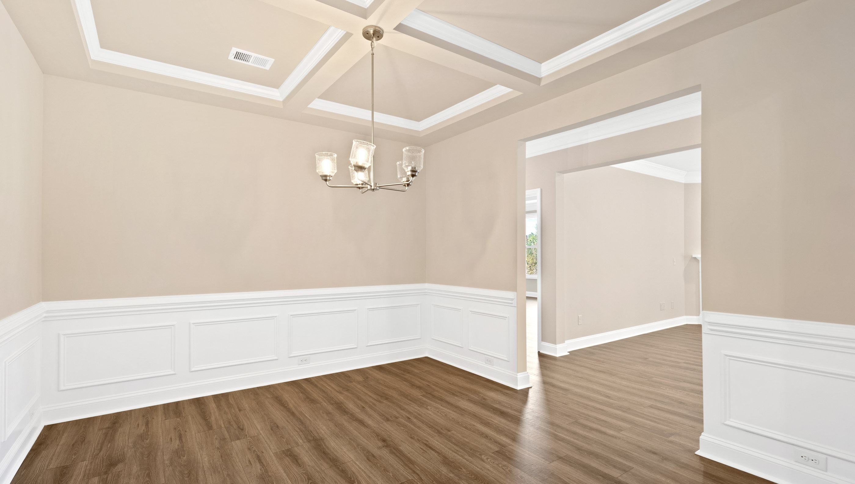 Formal dining room with coffered ceiling.
