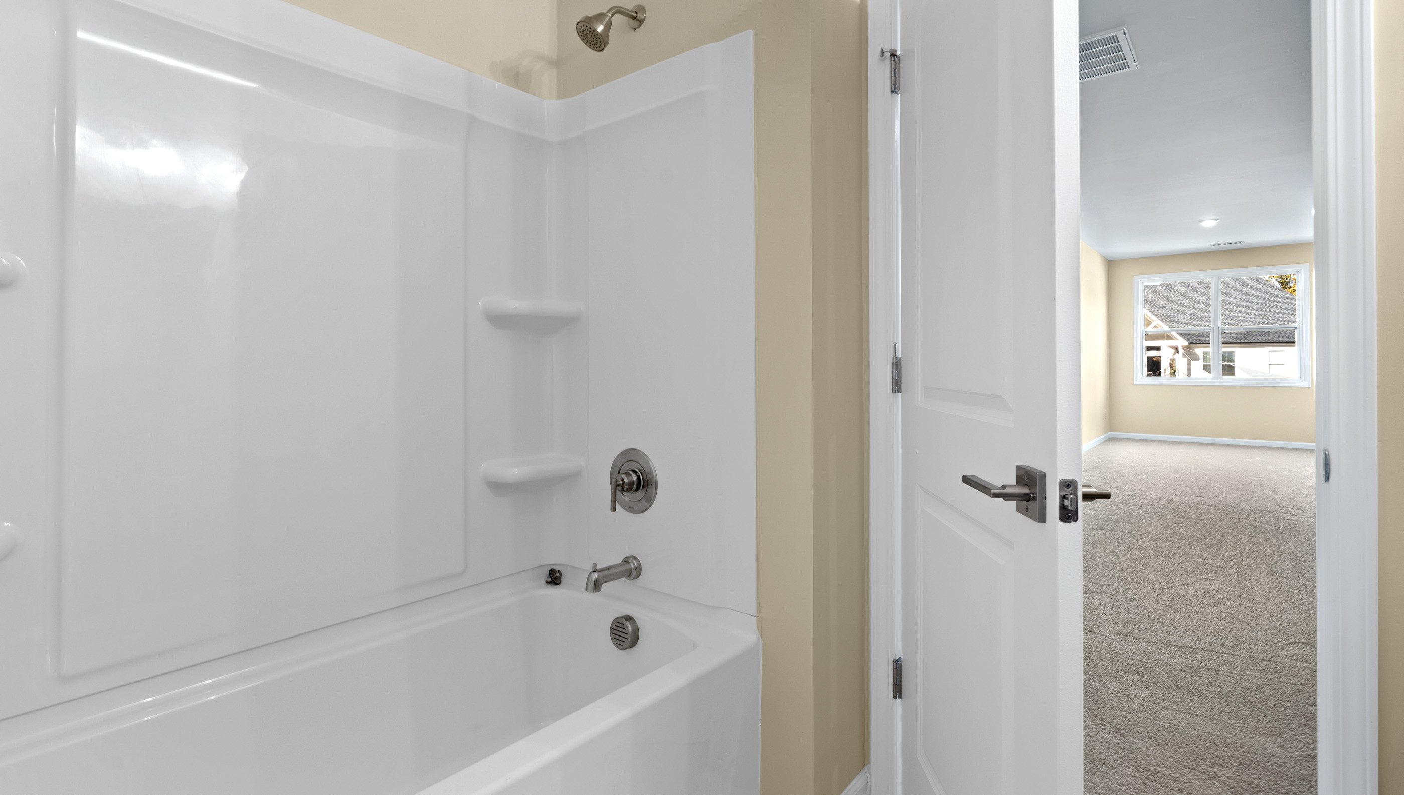 Upper level bathroom with vanity and combination shower / tub.