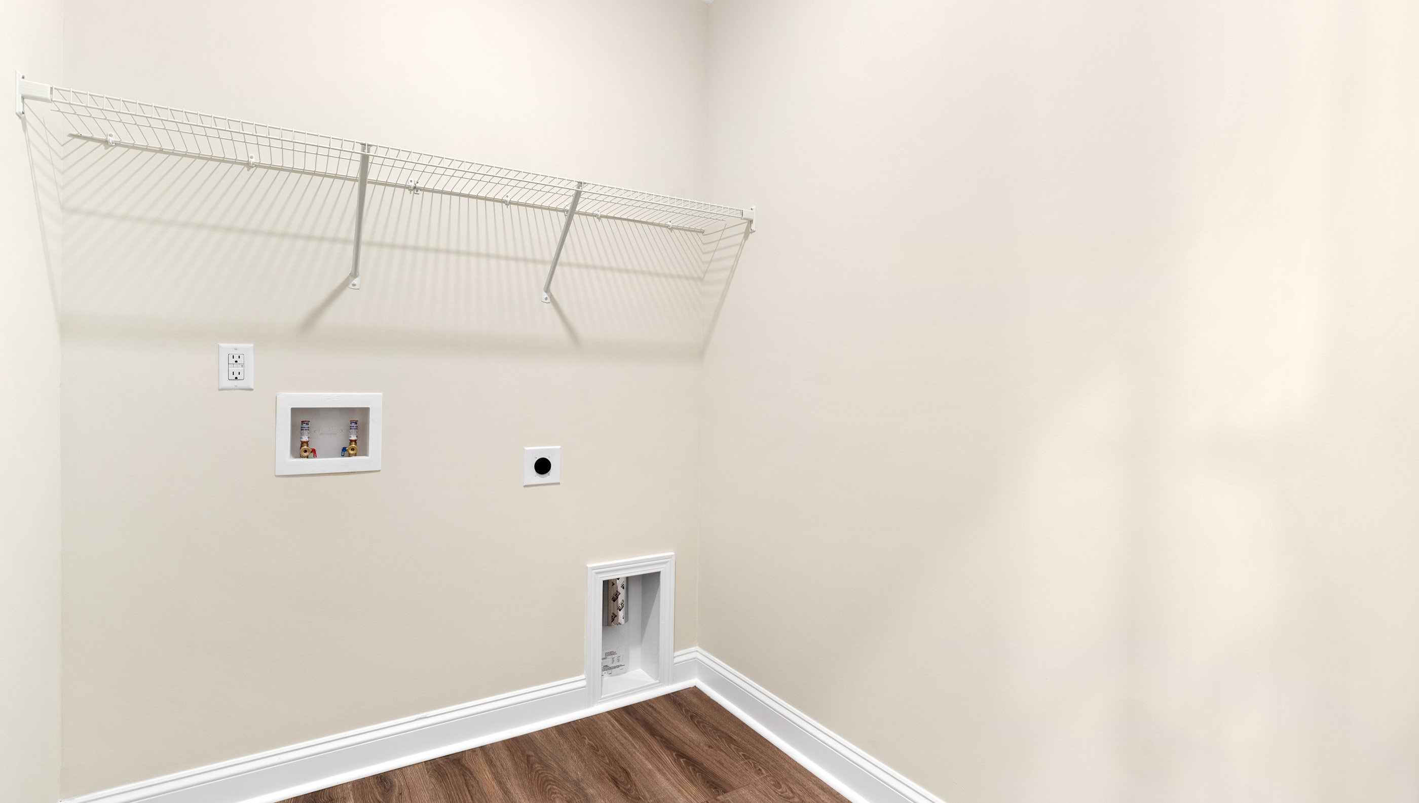 Walk-in laundry room with shelving.