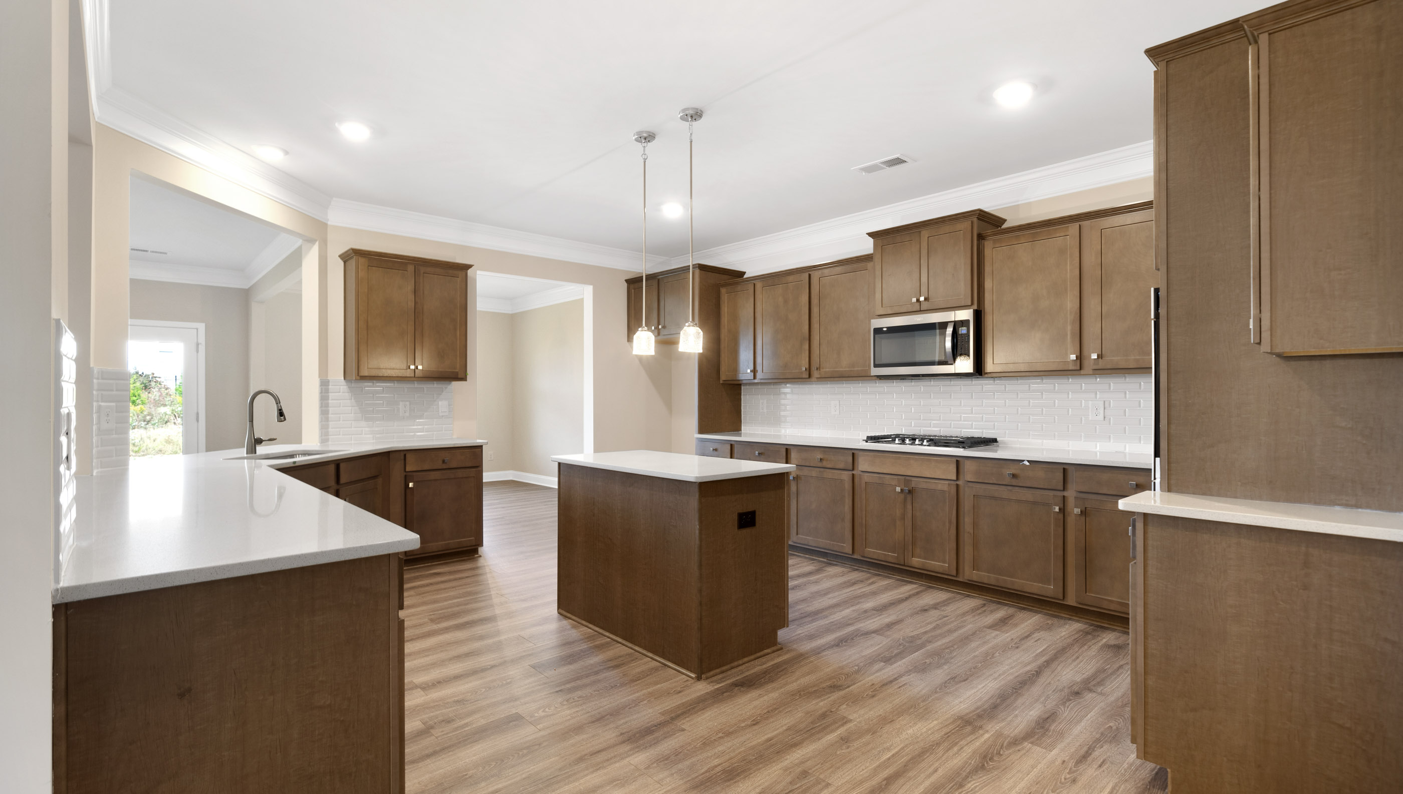 Large kitchen with lots of cabinets and island.