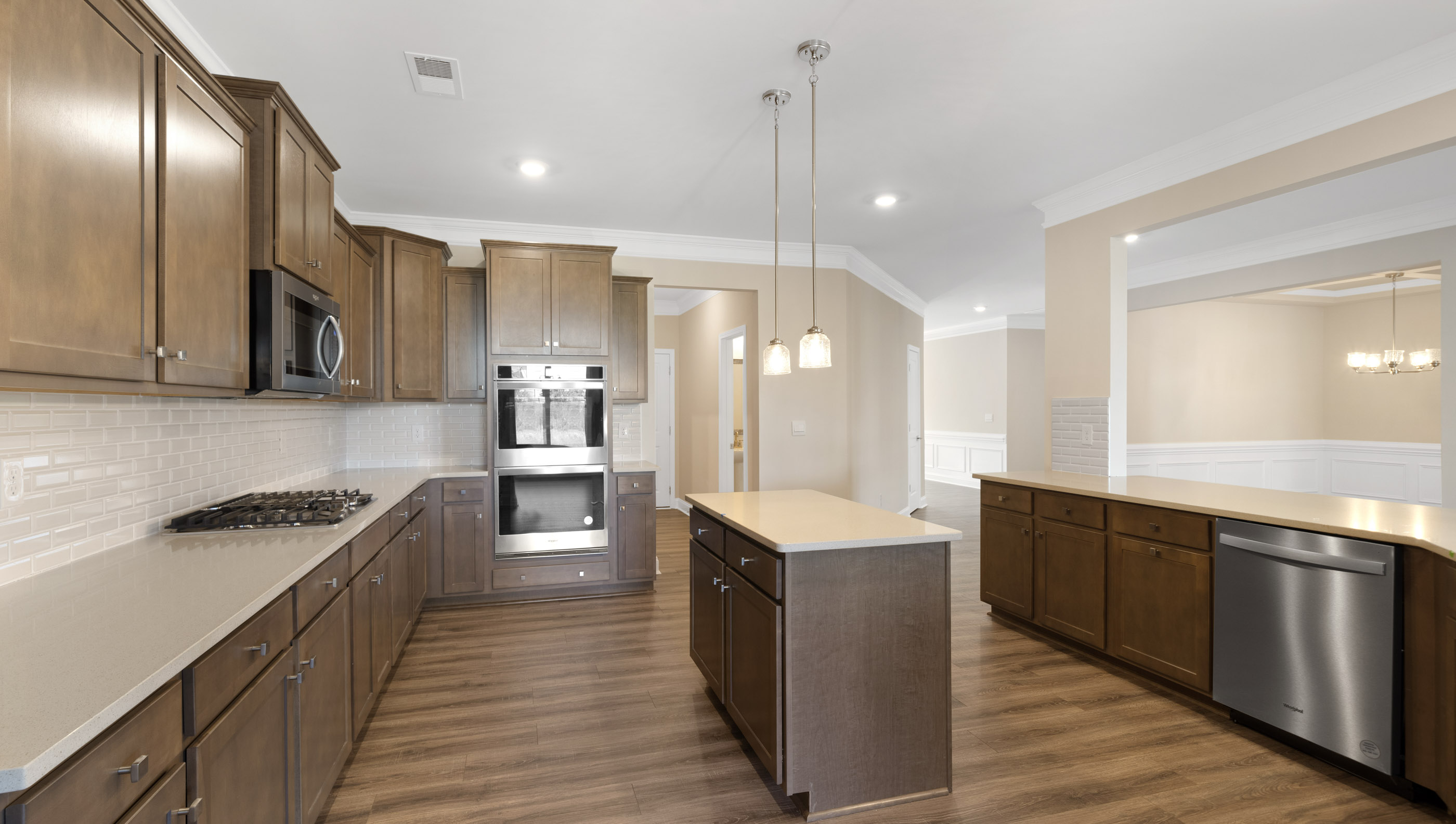 Kitchen and island have quartz countertops.