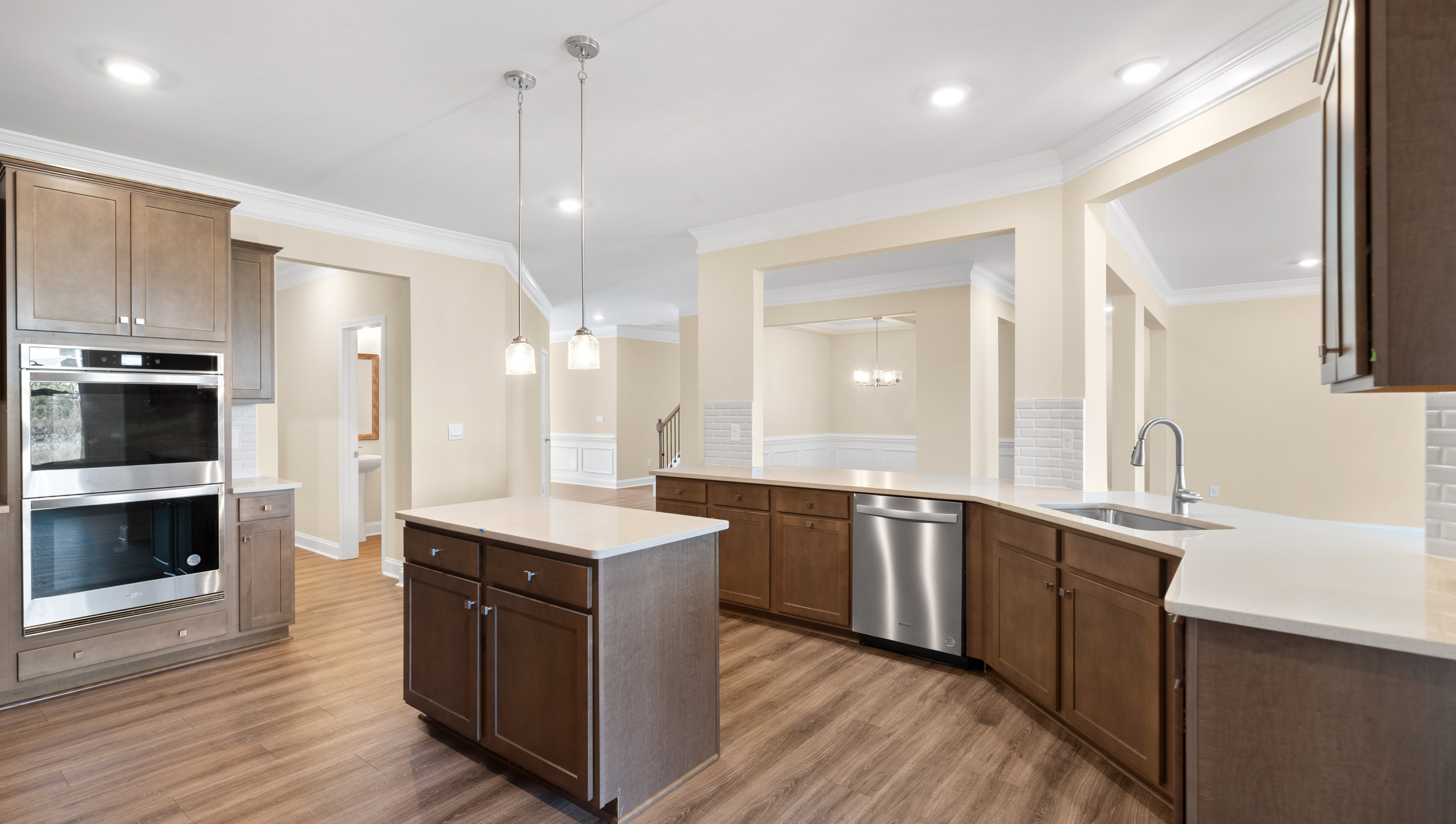 Kitchen has double ovens and stainless steel appliances.