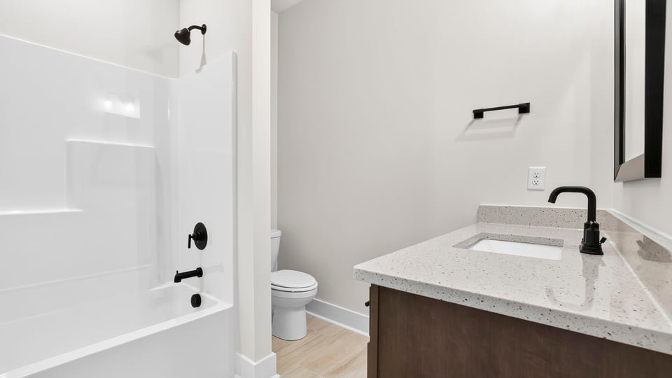 Bathroom with single vanity sink and bathtub.