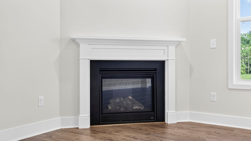Family room with fireplace and window.