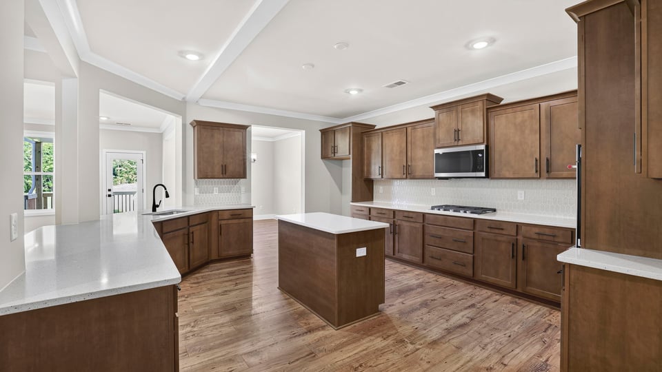 Kitchen and island with stainless steel appliances.