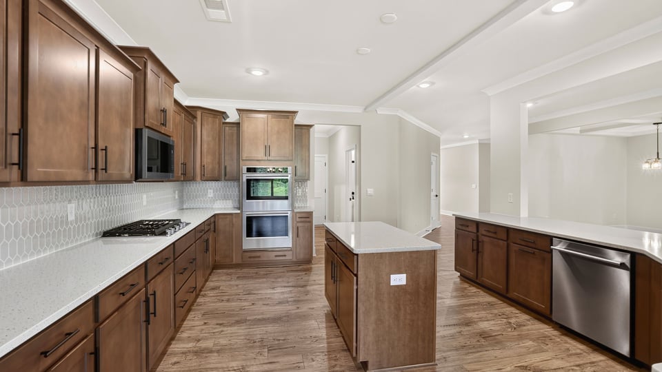 Kitchen and island with stainless steel appliances.