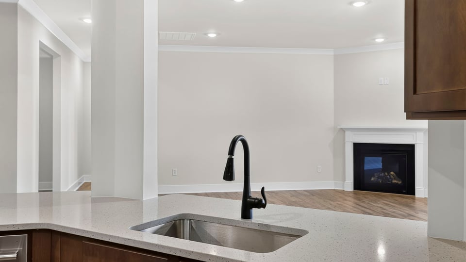 Kitchen and island with stainless steel appliances.