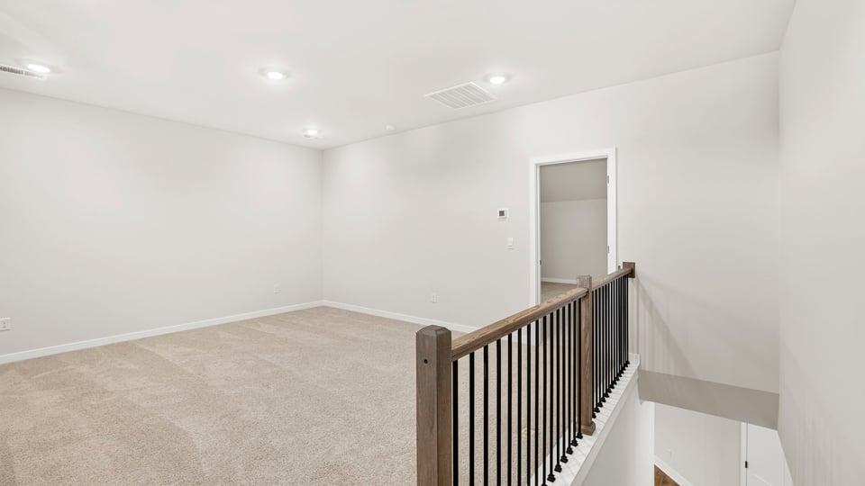 Loft area with carpet.