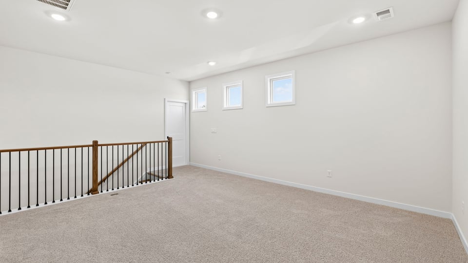Loft area with carpet.