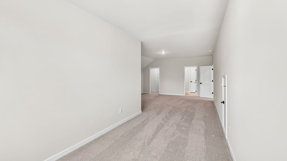 Loft area with carpet.