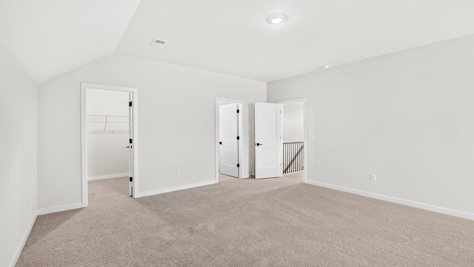 Bedroom with carpet and window.
